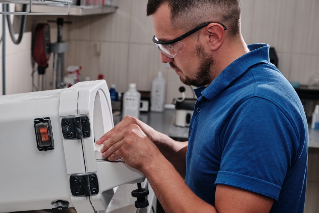 medical technician inspecting equipment